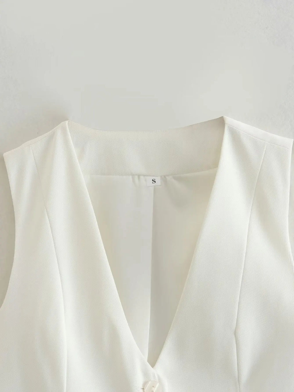 เสื้อกั๊กคลุมสตรีคอวีแขนกุดสไตล์วินเทจสีขาวสุดเก๋
