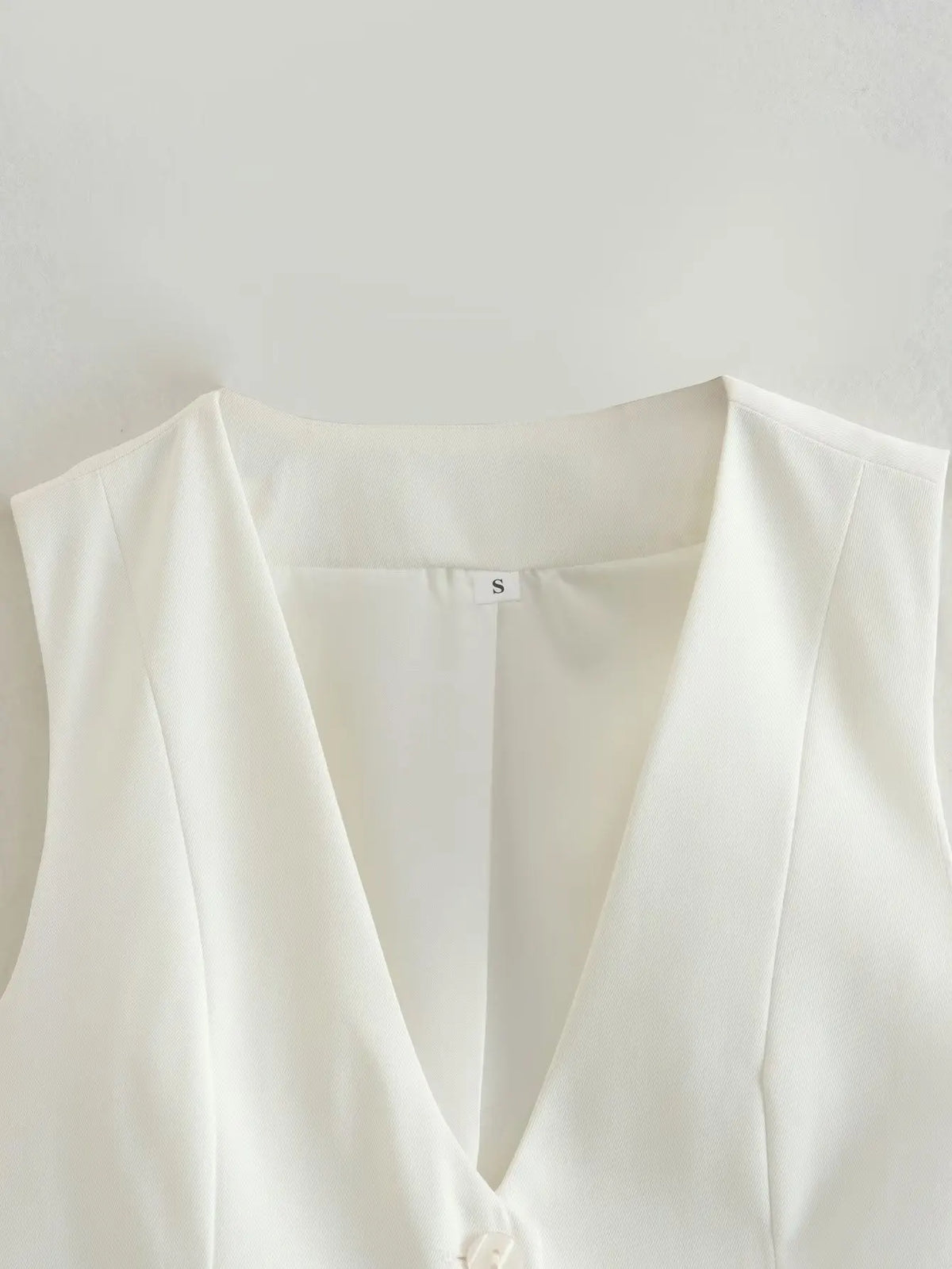เสื้อกั๊กคลุมสตรีคอวีแขนกุดสไตล์วินเทจสีขาวสุดเก๋